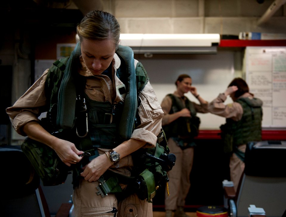 US Navy 120125-N-DR144-043 Pilot Lt. Ashley Ruic, assigned to Carrier Airborne Early Warning Squadron (VAW) 125, dresses out in the squadron's read