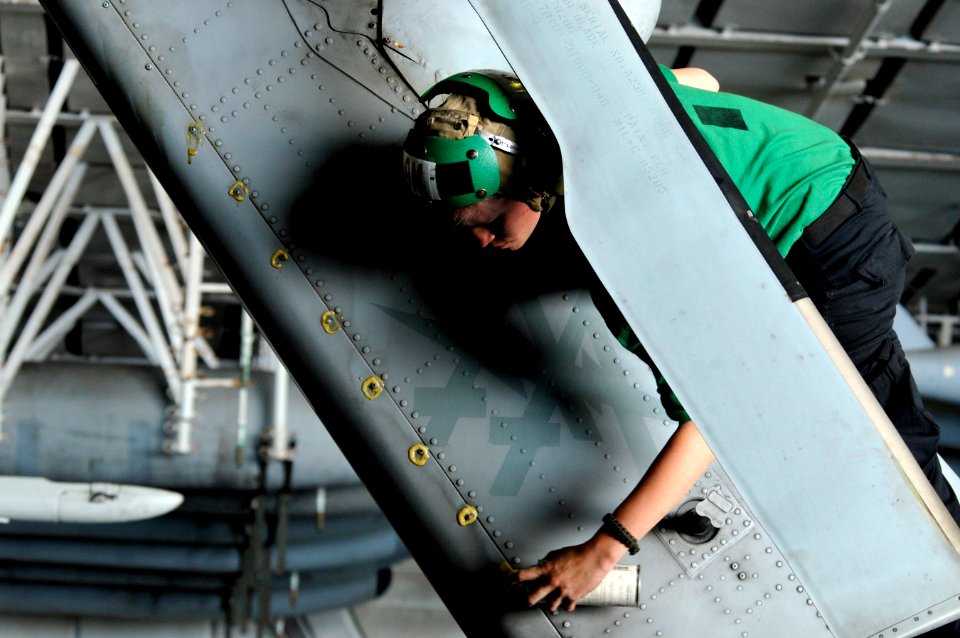 US Navy 120122-N-UT411-090 Aviation Structural Mechanic Airman Amy Landosky, assigned to Helicopter Anti-Submarine Squadron (HS) 15, performs corro