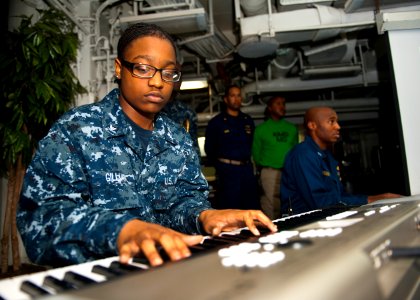 US Navy 120123-N-FI736-131 Information Systems Technician 3rd Class Kentara Gillard plays music during a Dr. Martin Luther King, Jr. birthday celeb
