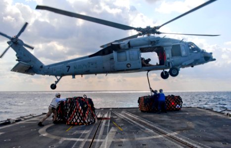 US Navy 120121-N-VY256-068 Sailors aboard the Ticonderoga-class guided-missile cruiser USS Cape St. George (CG 71) attach outgoing mail to an MH-60