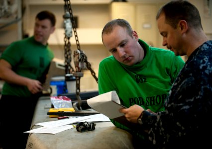 US Navy 120123-N-DR144-271 Aviation Electronics Technician 3rd Class Matthew Murphy, left, assigned to Aircraft Intermediate Maintenance Department