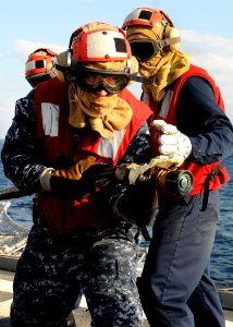 US Navy 120125-N-BC134-153 Damage Controlman 3rd Class Paul Kriewall practices firefighting techniques during a crash and smash drill aboard the gu