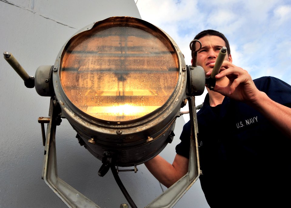 US Navy 120125-N-NL401-269 A Sailor aboard the Arleigh Burke-class guided-missile destroyer USS James E. Williams (DDG 95) uses a fog light as a wa