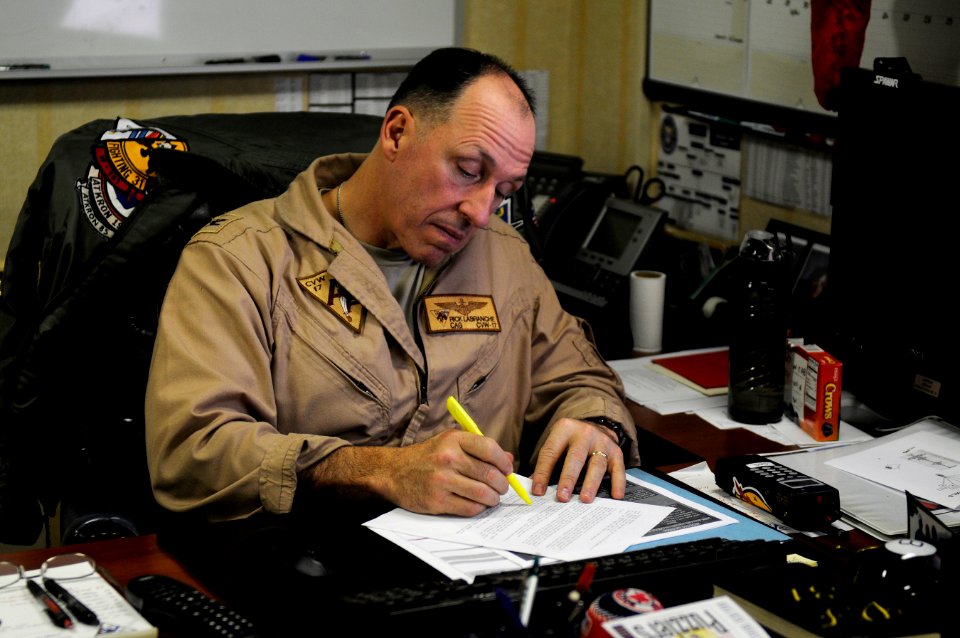 US Navy 120122-N-RG587-021 Capt. Rick LaBranche, commander of Carrier Air Wing (CVW) 17, reviews documents in his office aboard the Nimitz-class ai