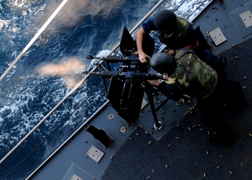 US Navy 120124-N-BC134-346 Sailors fire a dual-mounted M-240 machine gun during a live-fire exercise aboard the guided-missile cruiser USS Bunker H