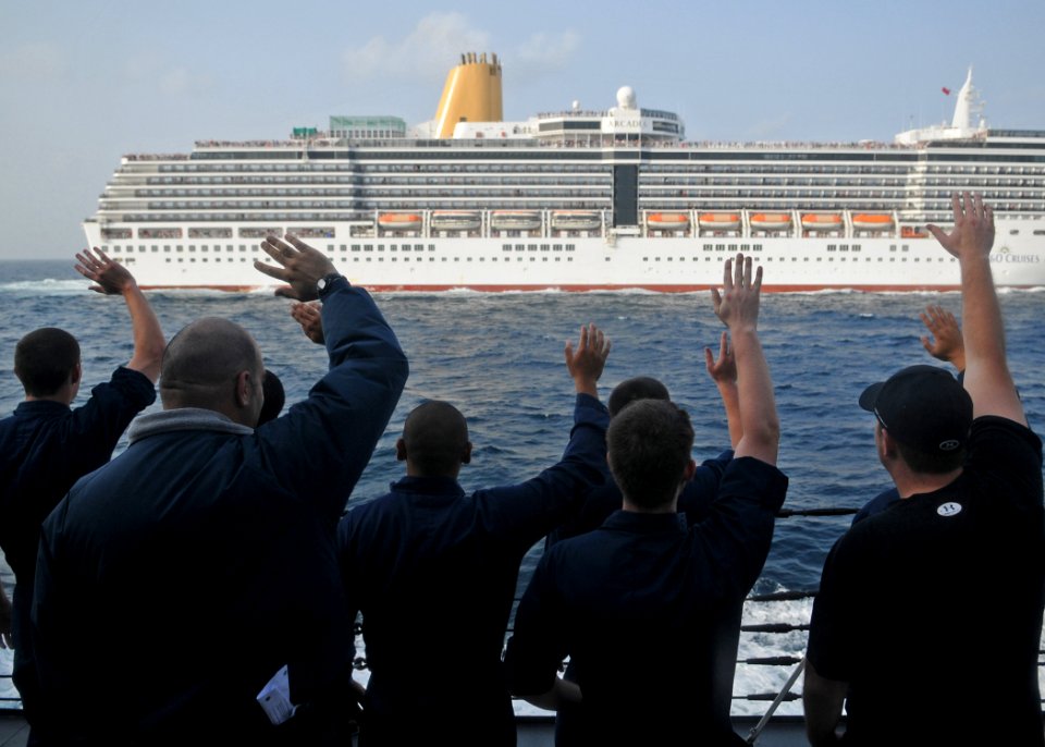 US Navy 120124-N-ZF681-268 Sailors aboard the guided-missile destroyer USS Halsey (DDG 97) wave at the cruise ship Arcadia as it passes