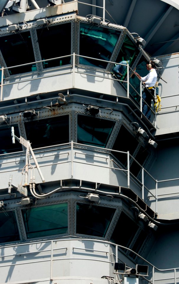US Navy 120123-N-OY799-023 Airman James Campbell wipes down a window on the island aboard the Nimitz-class aircraft carrier USS John C. Stennis (CV