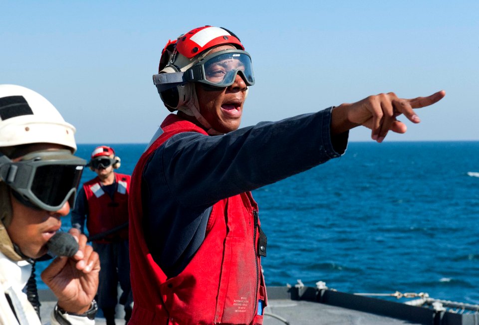 US Navy 120124-N-VY256-023 Damage Controlman 2nd Class Kareem Haughton calls out commands to firefighting teams during a mass casualty drill aboard