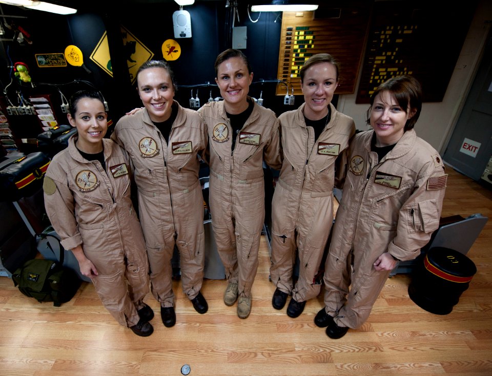US Navy 120125-N-DR144-012 Members pose for a photo before flying the first all-female-crewed combat mission in an E-2C Hawkeye, aboard the Nimitz