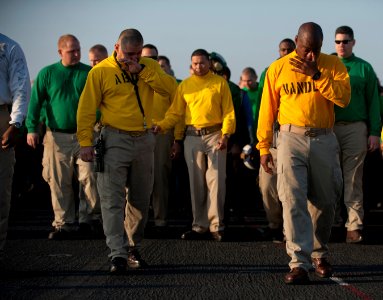US Navy 120125-N-DR144-525 Master Chief Aviation Boatswain's Mate Raul Castillo, left, and Aircraft Handling Officer Lt. Cmdr. Tommy Edgeworth, wip