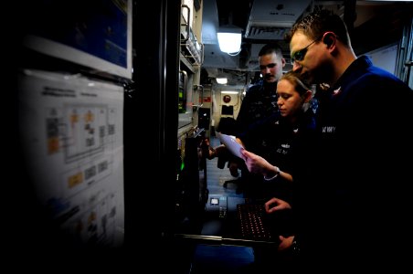 US Navy 120125-N-MD252-497 Sailors configure the global broadcast system in the main communications space