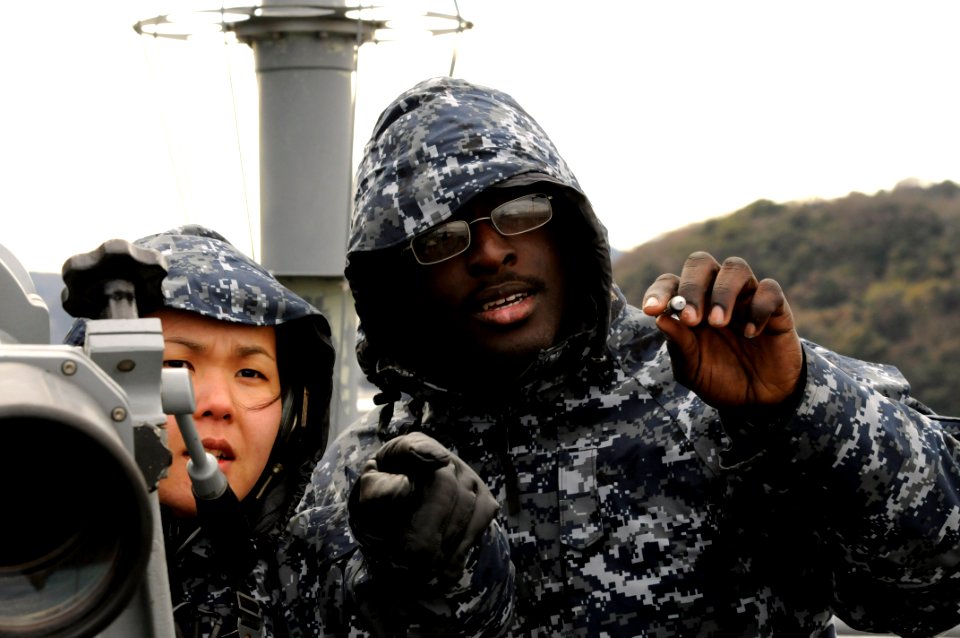 US Navy 120124-N-DB801-331 Operations Specialist Seamen Stephanie Nukhai, left, and Isaac Boyd train on navigation watchstanding on the port bridge