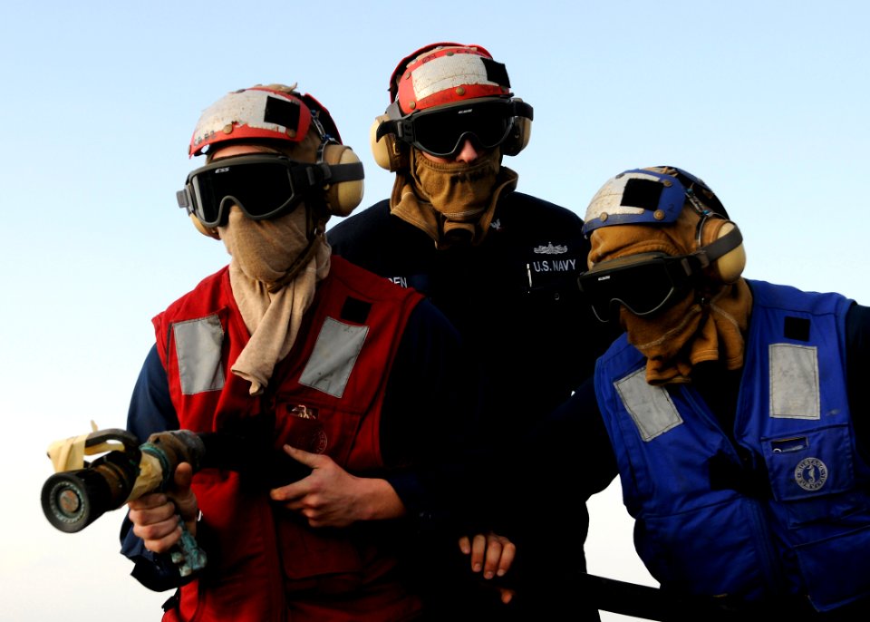 US Navy 120125-N-BC134-137 Sailors aboard the guided-missile cruiser USS Bunker Hill (CG 52) practice firefighting techniques during a crash and sm