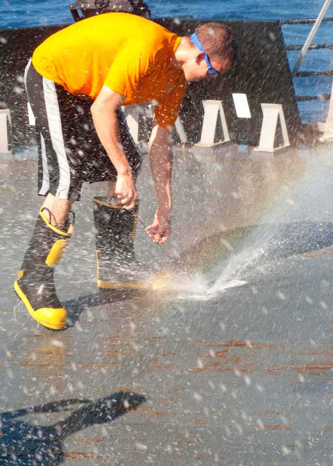 US Navy 120128-N-OH194-117 Machinery Repairman 3rd Class Tyler long adjusts a sprinkler group during an operational test of the countermeasure wash