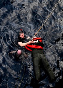 US Navy 120130-N-BC134-135 Damage Controlman 2nd Class Michael Johnson performs training on search and rescue techniques aboard the guided-missile