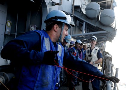 US Navy 120126-N-BC134-180 Seaman Michael Coyne heaves a shot line aboard the guided-missile cruiser USS Bunker Hill (CG 52) photo