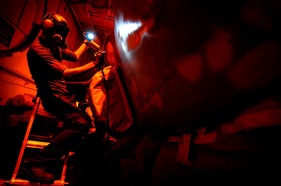 US Navy 120125-N-MD252-621 Aviation Structural Mechanic Airman David Southworth, assigned to Electronic Attack Squadron (VAQ) 134, paints an EA-6B