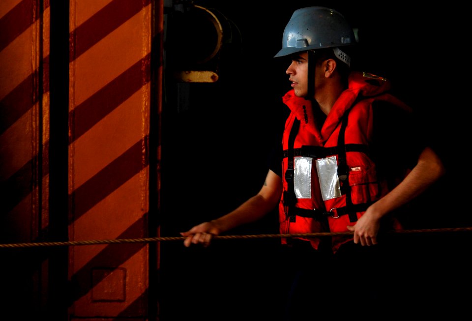 US Navy 120126-N-UT411-063 A Sailor brings in the messenger line during a replenishment at sea with the Military Sealift Command fast combat suppo