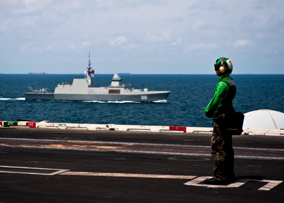 US Navy 120130-N-BT887-340 A Sailor from Helicopter Maritime Strike Squadron (HSM) 71 stands by aboard the Nimitz-class aircraft carrier USS John C