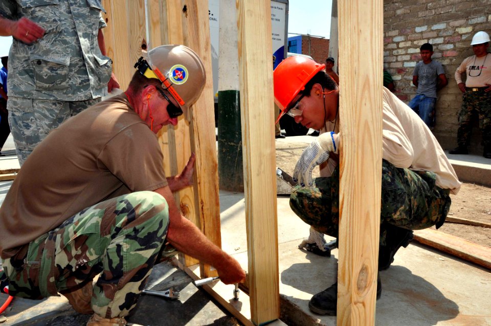 US Navy 120127-A-TF780-223 Utilitiesman 1st Class, Bruce Nisbet and a Navy combat engineer from the Peruvian Infanteria De Marina tighten a screw o