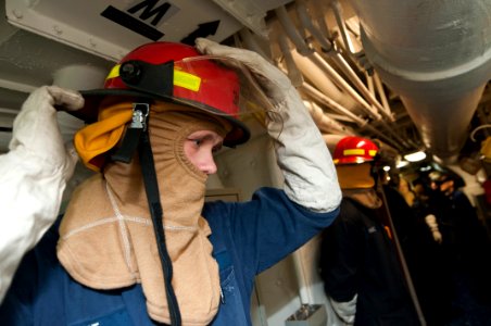 US Navy 120130-N-PB383-002 A Sailor dons firefighting equipment during a total ship survivability exercise