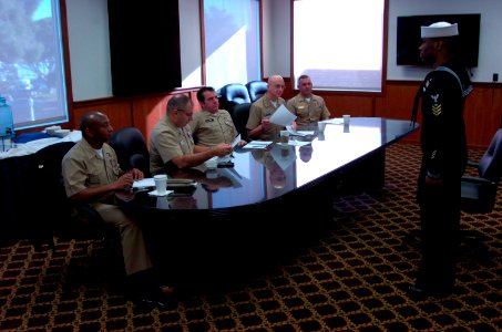 US Navy 120125-N-QP955-002 Fire Controlman 1st Class William D. Stanford II, assigned to Training Support Center Great Lakes, meets with senior enl