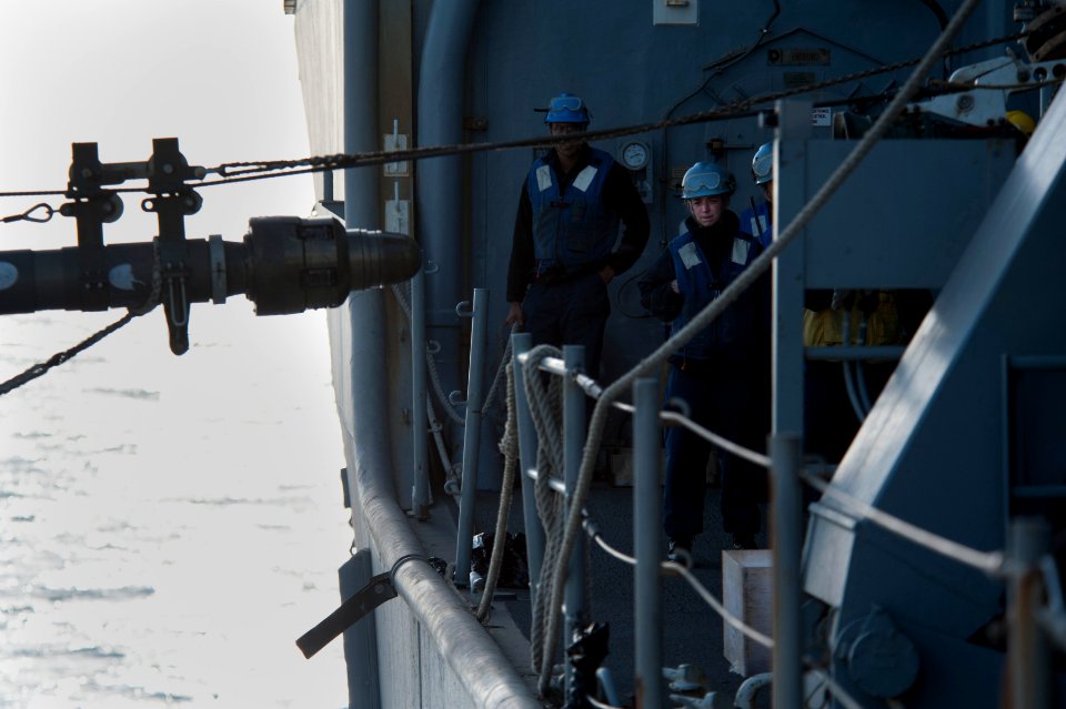 US Navy 120129-N-KS651-403 Sailors from the deck department of the amphibious dock landing ship USS Pearl Harbor (LSD 52) watch a fuel probe being