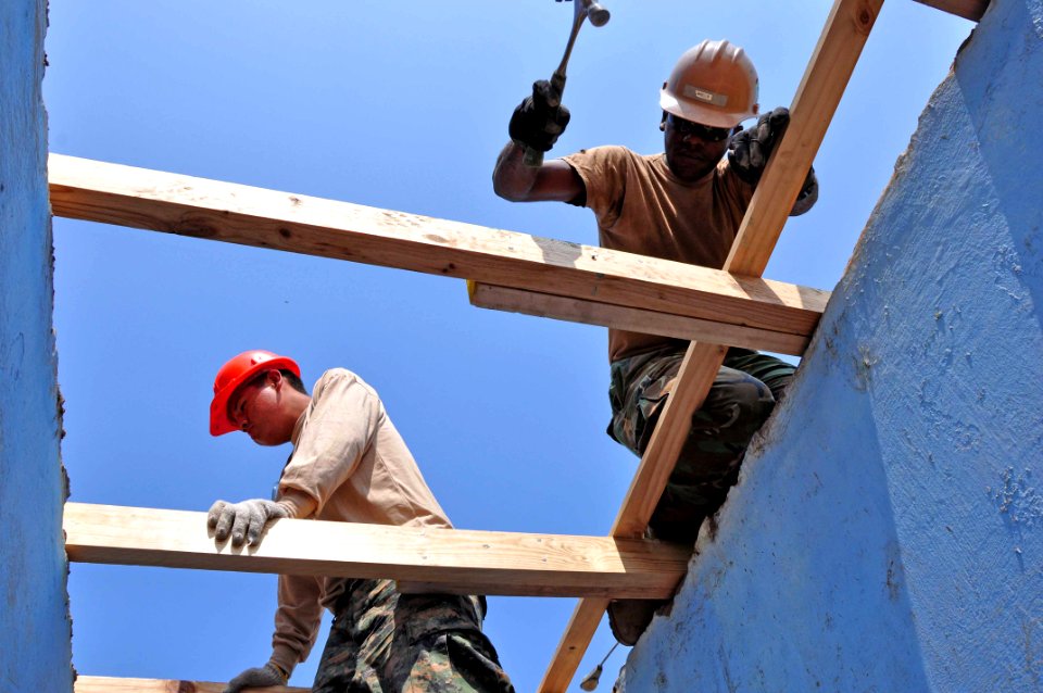 US Navy 120127-A-TF780-076 Equipment Operator 2nd Class Tyrif Wells and Peruvian combat engineers install a new roof at an elementary school