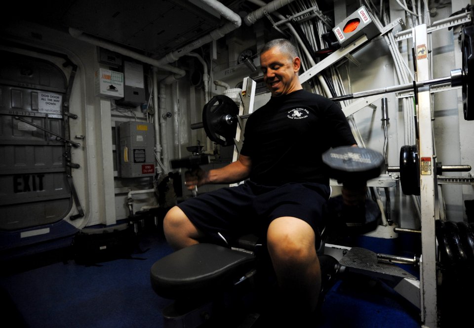 US Navy 120127-N-JN664-035 Seaman Dagan Alexander lifts weights in the signal shack aboard the Nimitz-class aircraft carrier USS Abraham Lincoln (C