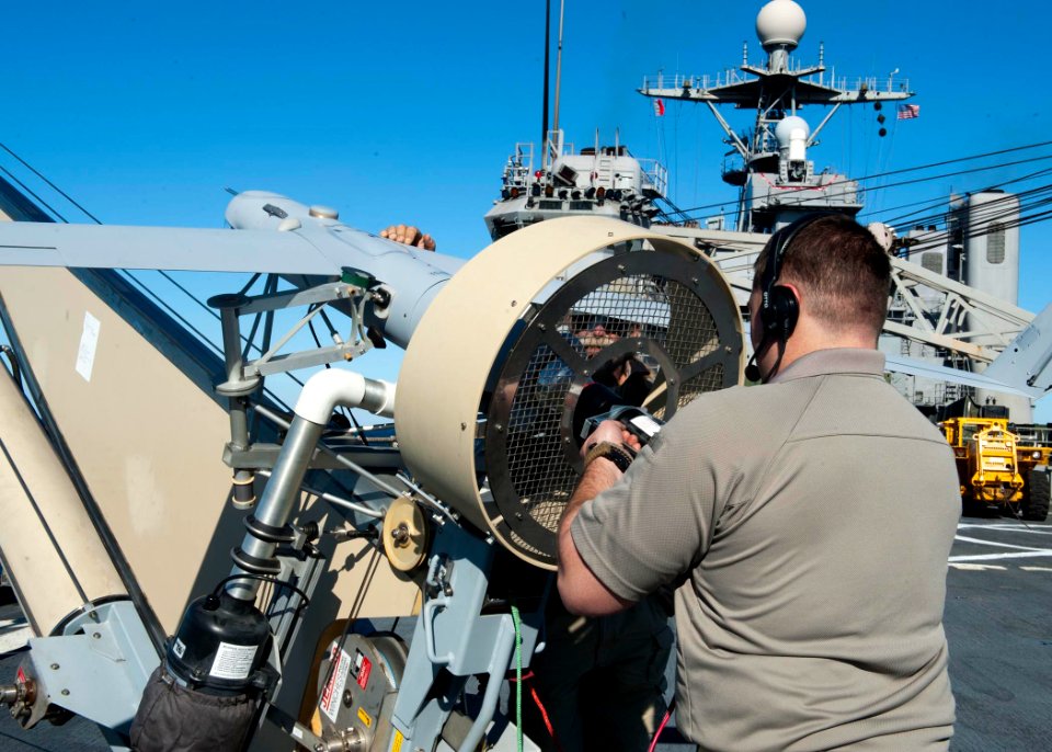 US Navy 120130-N-NR955-058 nsitu and Boeing contractors prepare the unmanned aerial vehicle Scan Eagle for a test flight from the flight deck aboar