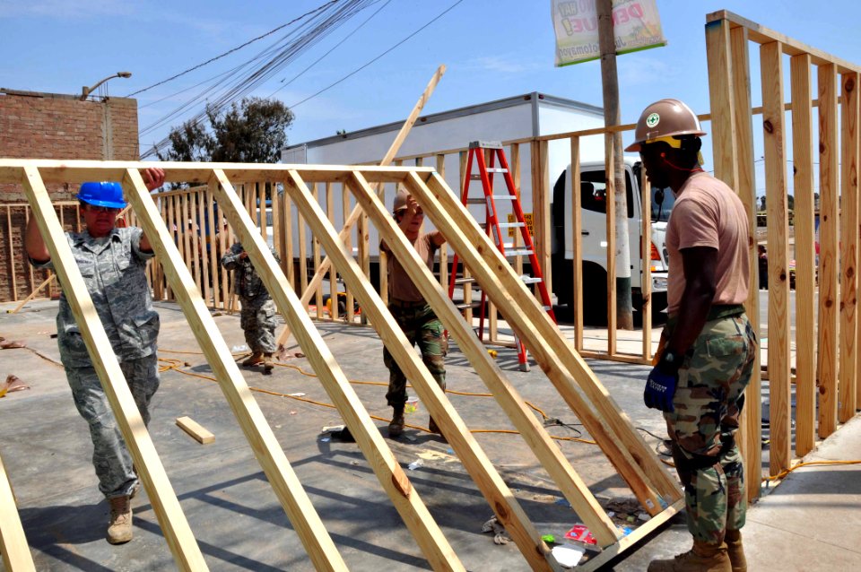 US Navy 120127-A-TF780-207 U.S. service members embarked aboard High Speed Vessel (HSV 2) Swift lift a pre-fabricated wall frame into place for a w