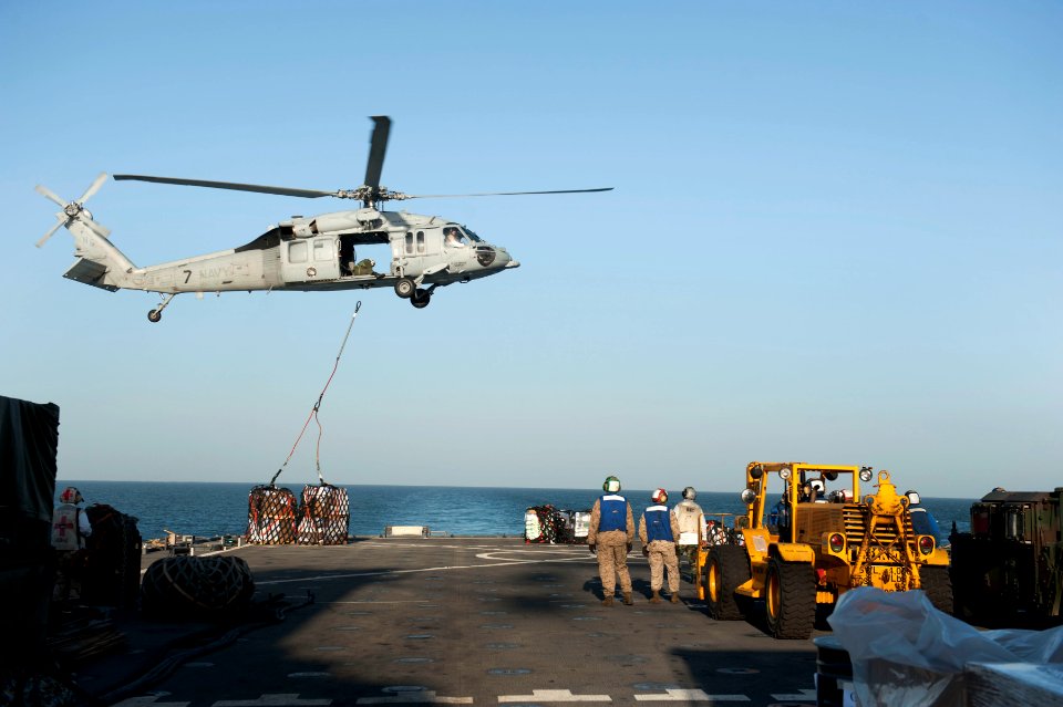 US Navy 120129-N-KS651-032 An MH-60S Sea Hawk helicopter assigned to Helicopter Sea Combat Squadron (HSC) 12 delivers cargo to the flight deck of t
