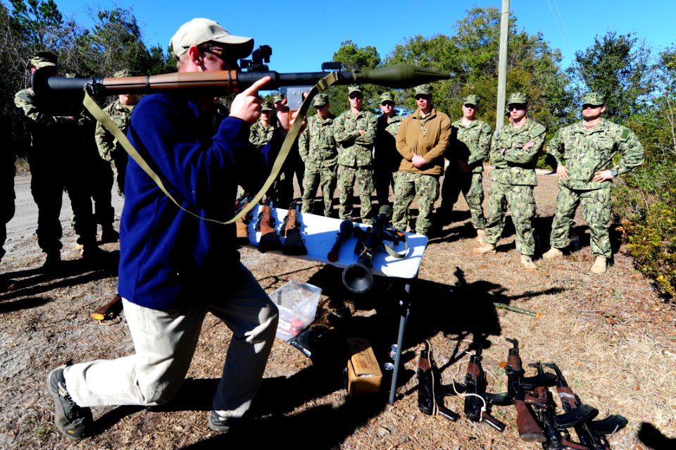 US Navy 120130-N-QD416-079 A lane controller with Defense Training Systems conducts a weapons familiarization class with members of Riverine Squadr