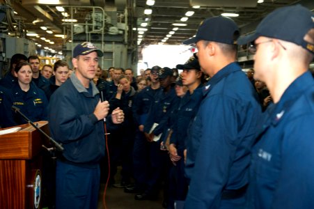 US Navy 120127-N-KS651-081 Cmdr. Homer Denius, commanding officer of the amphibious dock landing ship USS Pearl Harbor (LSD 52), addresses Sailors