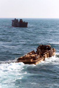 US Navy 120127-N-KS651-231 A landing craft utility and a lighter amphibious re-supply cargo conduct training operations in the wake of the amphibio