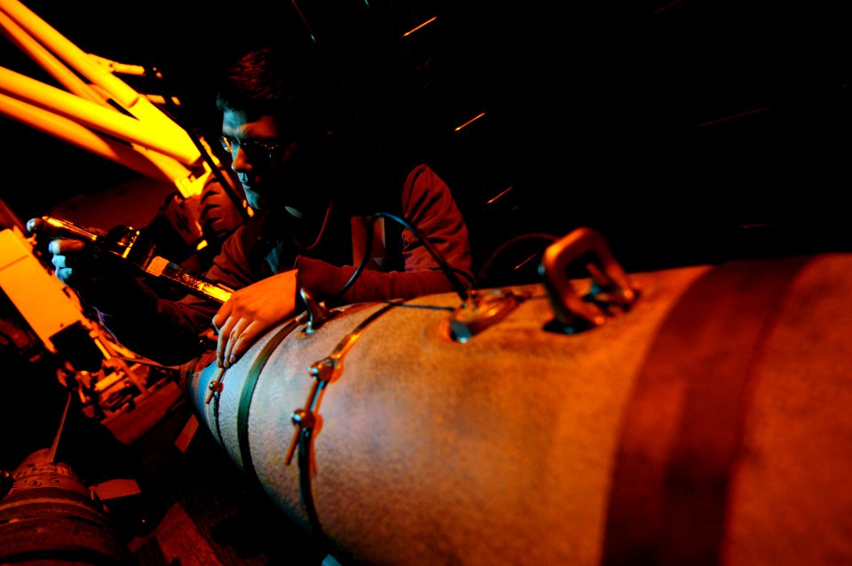 US Navy 120127-N-MD252-588 Aviation Ordnanceman Airman James Lewis inspects ordnance on the flight deck aboard the The Nimitz-class aircraft carrie