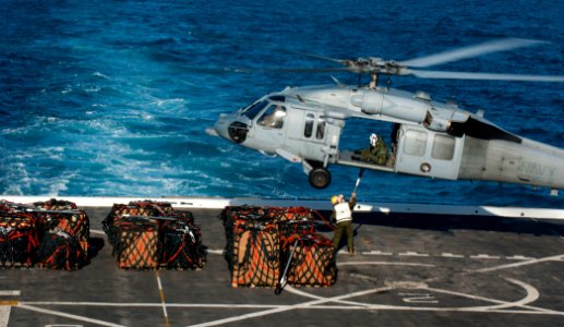 US Navy 120129-N-PB383-600 Marines attach cargo to an MH-60S Sea Hawk helicopter embarked aboard the Military Sealift Command dry cargo and ammunit