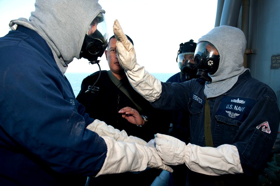 US Navy 120129-N-KS651-541 Sailors aboard the amphibious dock landing ship USS Pearl Harbor (LSD 52) simulate the decontamination process during a