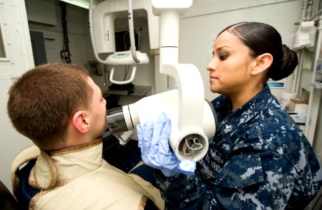 US Navy 120131-N-JN664-014 Hospital Corpsman 1st Class Laura Blanco takes X-rays of Electrician's Mate 1st Class Cory Hartley aboard the Nimitz-cla