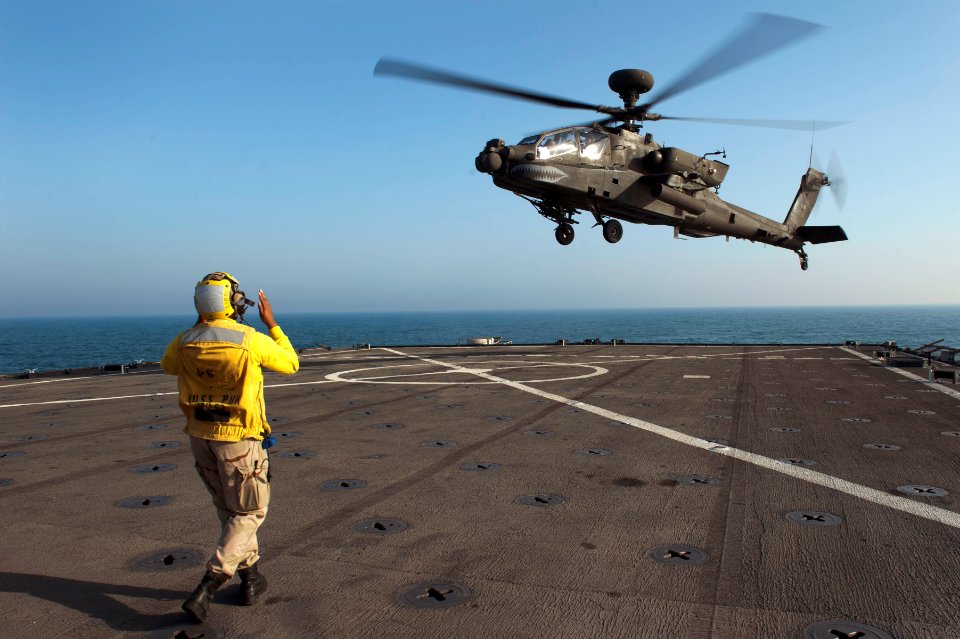 US Navy 120128-N-KS651-305 A Sailor signals a helicopter to land on the flight deck of USS Pearl Harbor