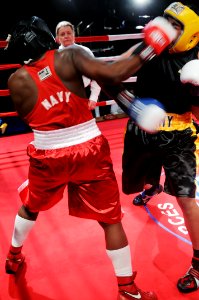 US Navy 120131-N-ZZ999-718 Hospitalman Brandon Wicker smashes a right hook into Army Sgt. Charles Blackwell in the preliminaries of the 2012 Armed