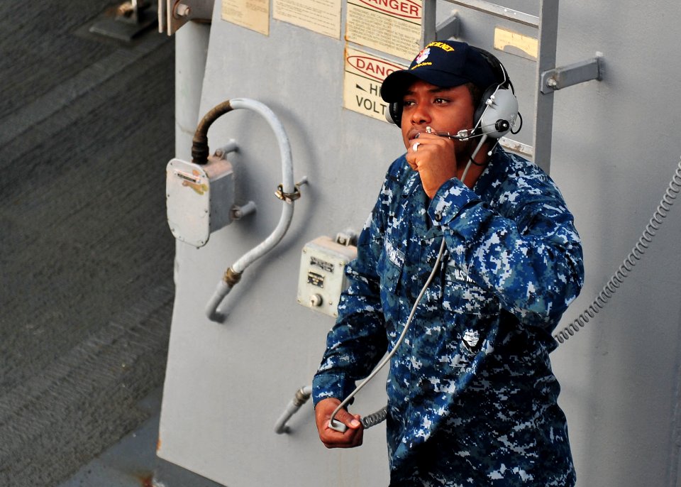 US Navy 120130-N-ED900-014 A Sailor communicates with the bridge prior to leaving Singapore