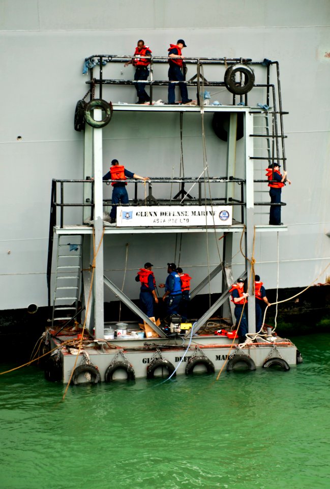 US Navy 120128-N-OY799-015 Sailors from Deck Department paint the side of the Nimitz-class aircraft carrier USS John C. Stennis (CVN 74) while in p