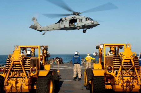US Navy 120129-N-KS651-321 An MH-60S Sea Hawk helicopter assigned to Helicopter Sea Combat Squadron (HSC) 12 hovers above the flight deck of the am