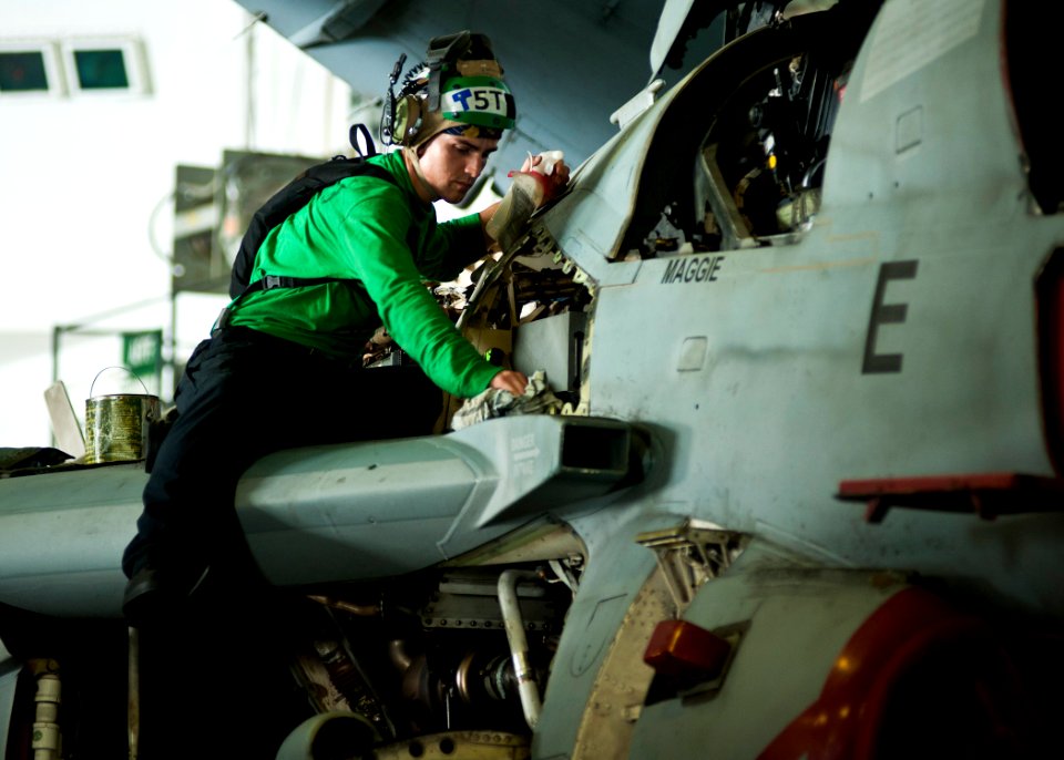 US Navy 120201-N-BT887-032 Aviation Electronics Technician 3rd Class Andrew Godwin wipes down an EA-6B Prowler from the Wizards of Electronic Attac
