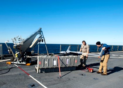 US Navy 120130-N-NR955-034 Contractors prepare the unmanned aerial vehicle Scan Eagle for take off on the flight deck aboard the Whidbey Island-cla