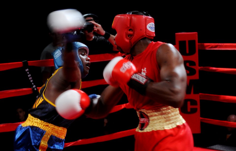 US Navy 120201-N-ZZ999-381 Hospital Corpsman Brandon Wicker, from Taunton, Mass., throws an over-head, right hook during a boxing match