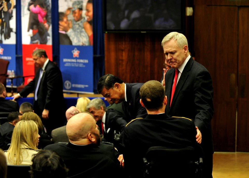 US Navy 120130-N-AC887-001 Secretary of the Navy (SECNAV) the honorable Ray Mabus speaks with a wounded warrior before first lady Michelle Obama de