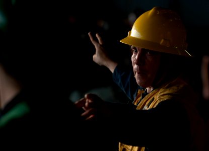 US Navy 120202-N-DR144-215 Rig captain Boatswain's Mate 2nd Class James Langley directs signalmen aboard the Nimitz-class aircraft carrier USS Carl