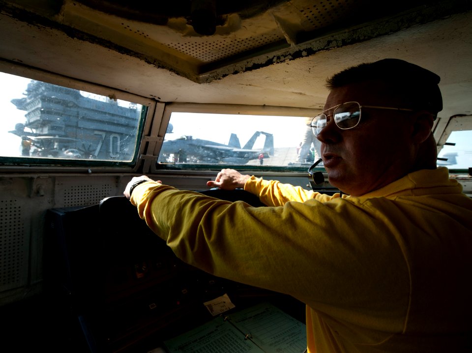 US Navy 120131-N-DR144-027 Shooter Lt. Brian Gaffney controls the launch of aircraft from the waist catapult control bubble aboard the Nimitz-class